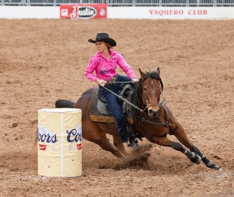 woman riding a horse at a rodeo