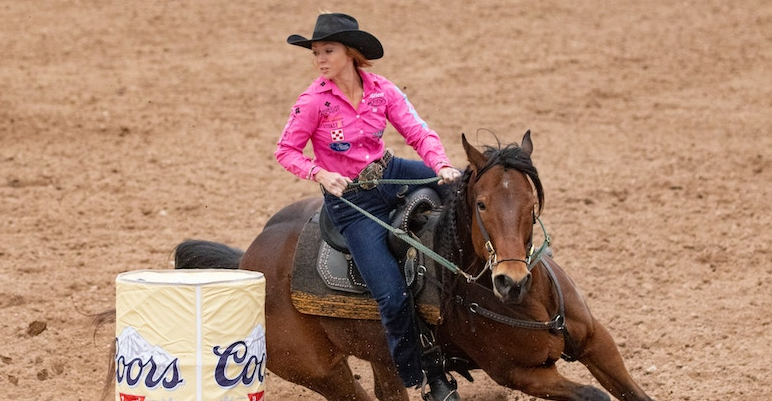 woman riding a horse at a rodeo