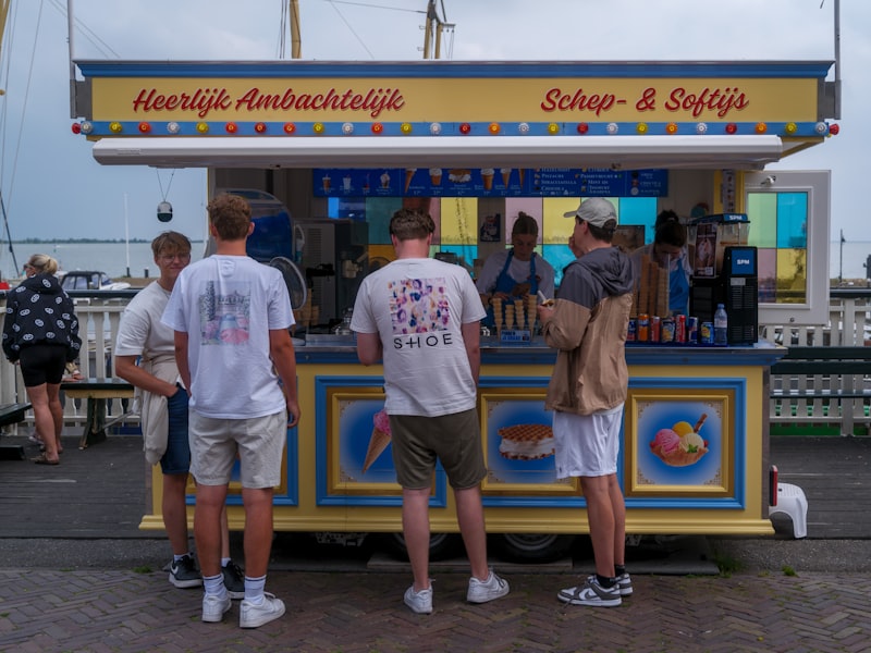 A queue of members ordering at a colorful concession stand